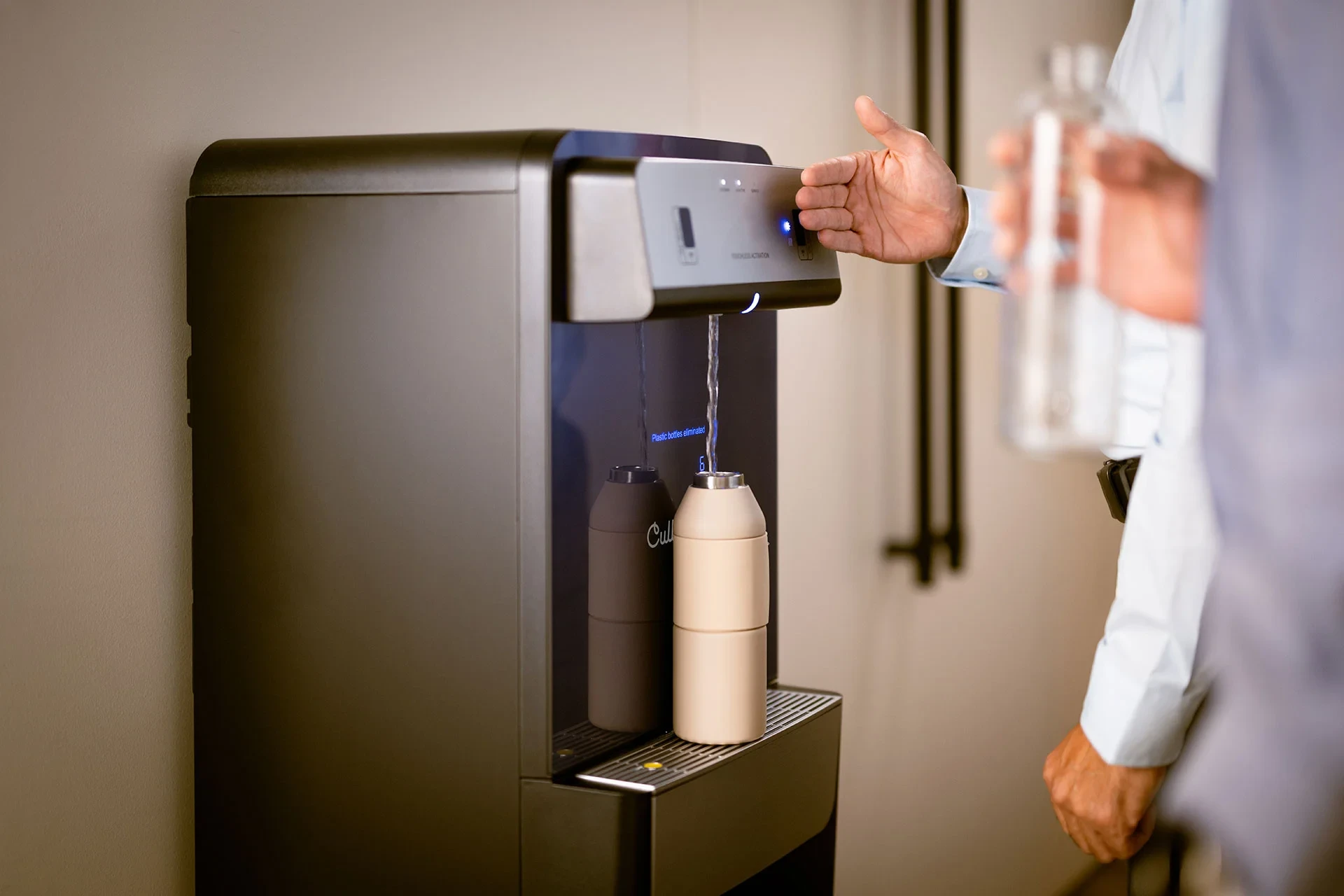 Bottleless water cooler filling a water bottle