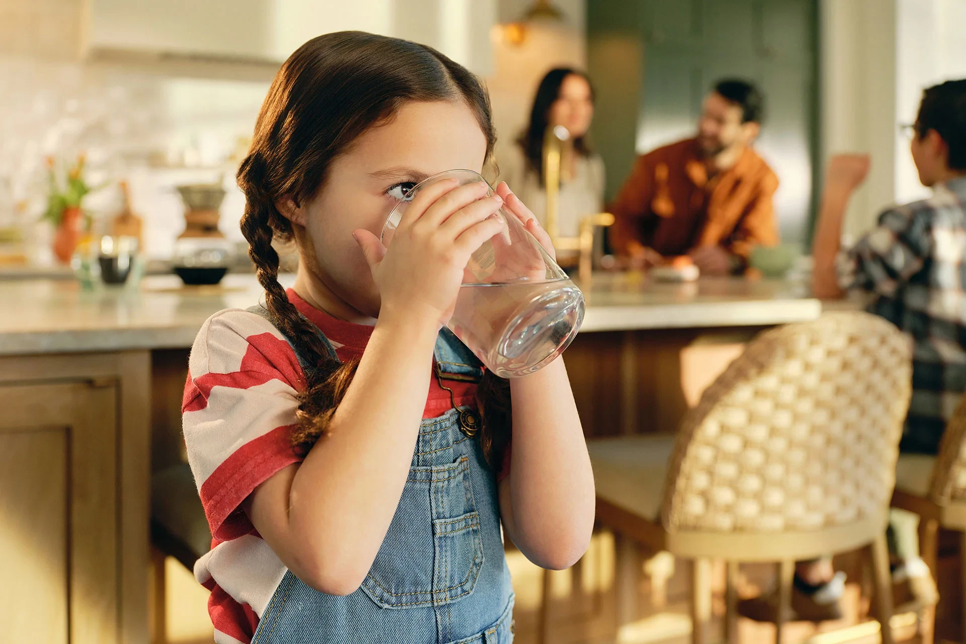Young girl drinking a glass of water
